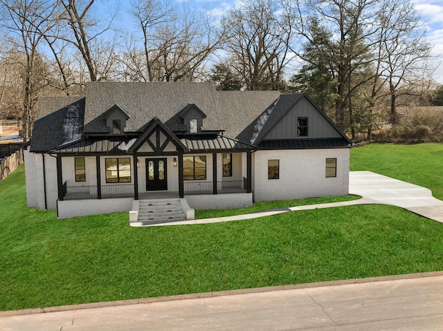 view of front of home with covered porch and a front lawn