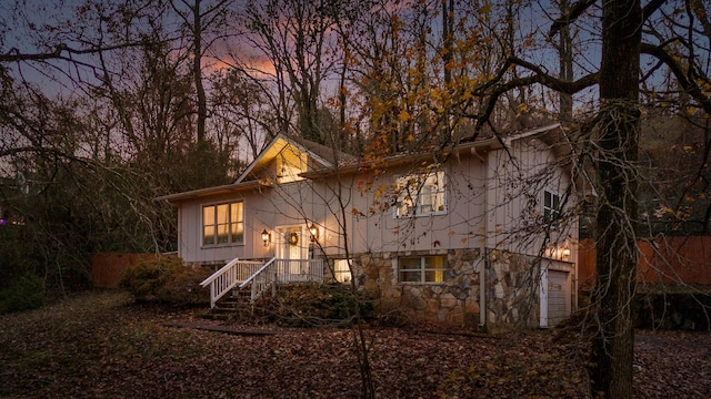 back house at dusk with a garage