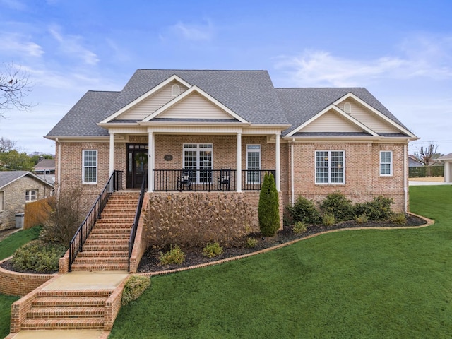 craftsman house featuring covered porch and a front yard