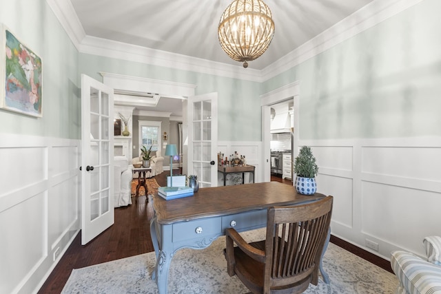 home office featuring dark hardwood / wood-style flooring, french doors, ornamental molding, and a notable chandelier