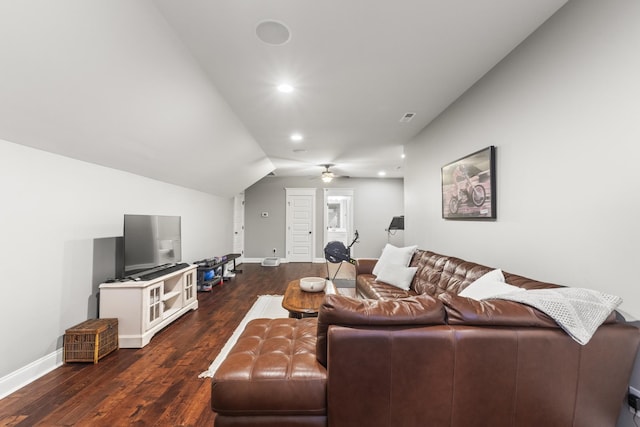 living room with ceiling fan, dark wood-type flooring, and vaulted ceiling