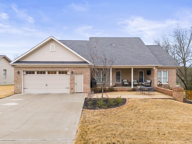 view of front facade with a garage, a porch, and a front yard