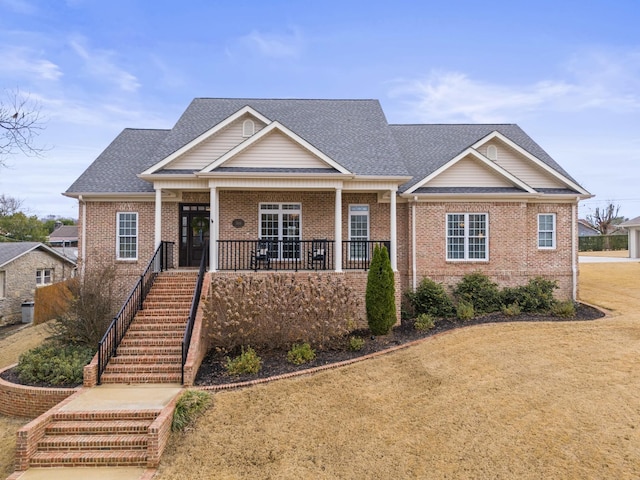 craftsman-style house with a porch and a front lawn