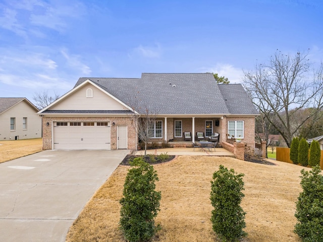 ranch-style house with covered porch and a garage