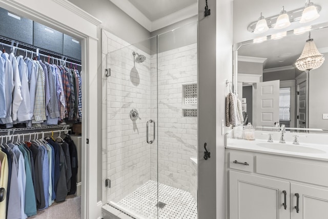 bathroom with vanity, crown molding, and walk in shower