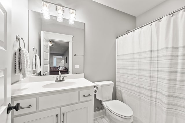 bathroom featuring ceiling fan, vanity, and toilet