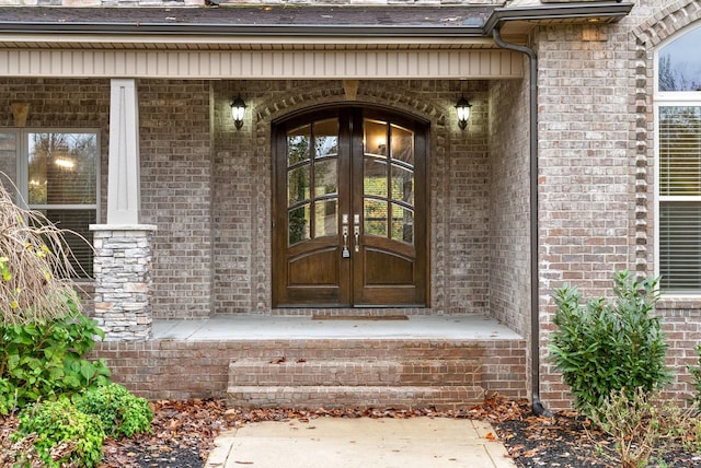 doorway to property featuring covered porch and french doors