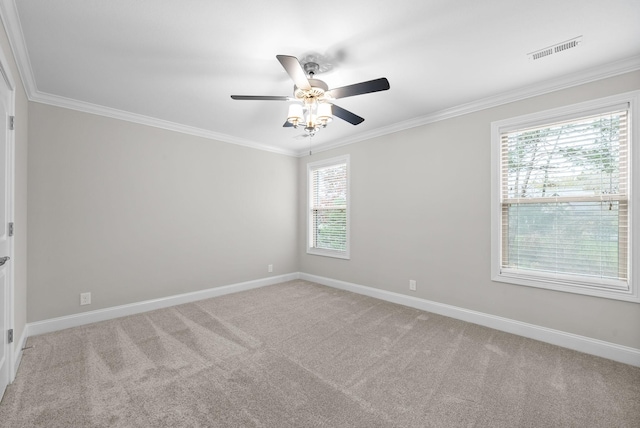 unfurnished room with light colored carpet, plenty of natural light, ornamental molding, and ceiling fan