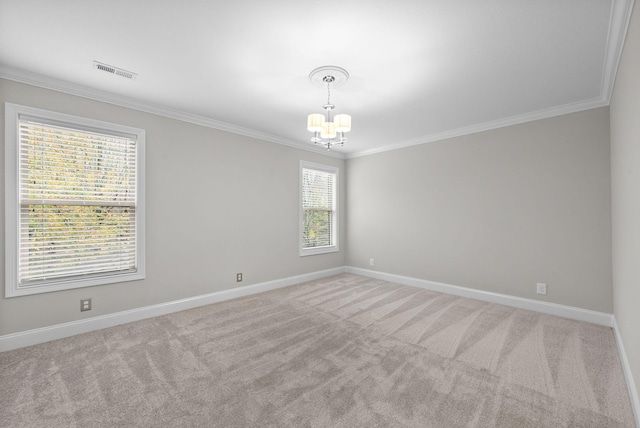 carpeted spare room featuring crown molding and a chandelier