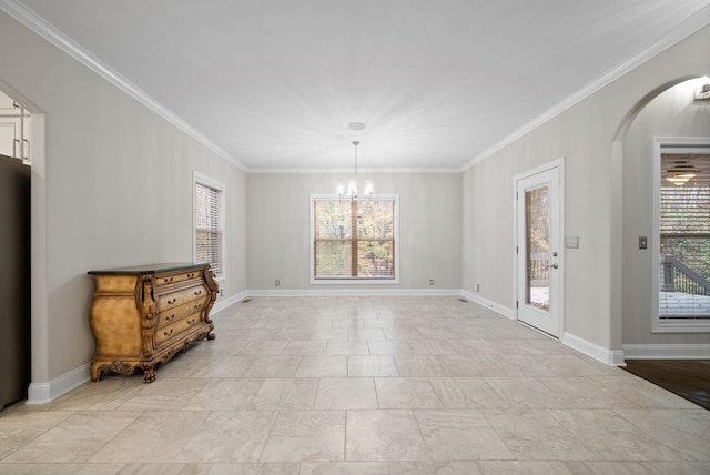 dining room with plenty of natural light, ornamental molding, and a chandelier