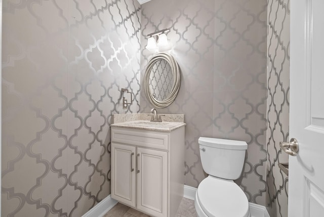 bathroom with tile patterned floors, vanity, and toilet