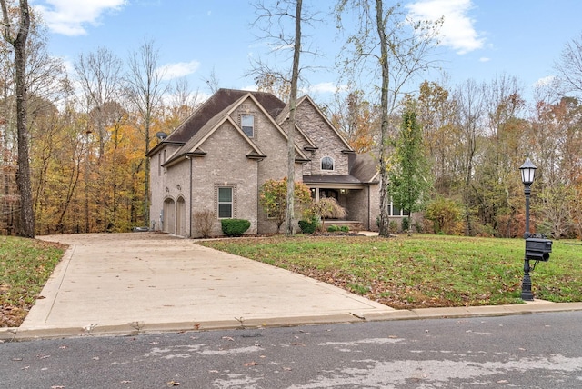 view of front of property with a front lawn and a garage