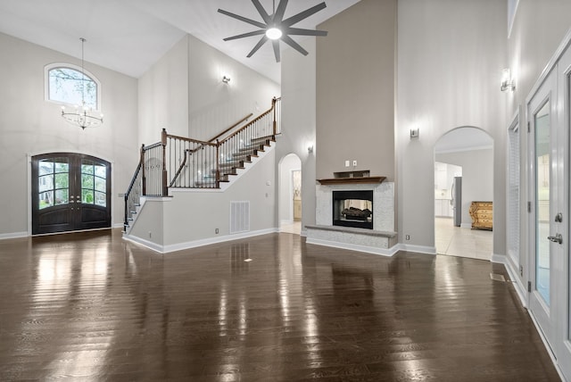 foyer entrance featuring french doors, high vaulted ceiling, a wealth of natural light, and dark wood-type flooring