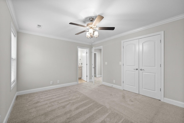 unfurnished bedroom featuring multiple windows, ceiling fan, light colored carpet, and ornamental molding