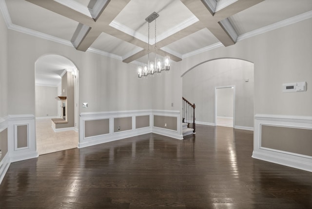 spare room featuring beamed ceiling, dark hardwood / wood-style flooring, and coffered ceiling