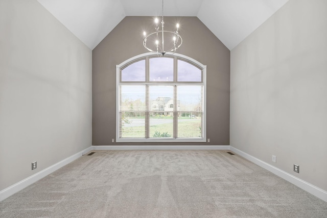 spare room with a notable chandelier, light colored carpet, and lofted ceiling