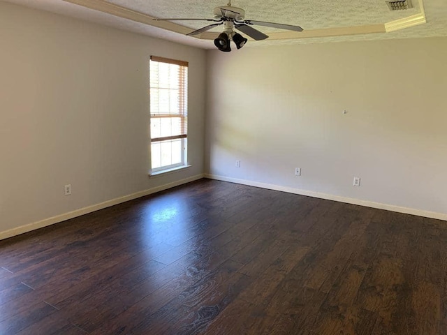 unfurnished room featuring ceiling fan, dark hardwood / wood-style flooring, and a textured ceiling