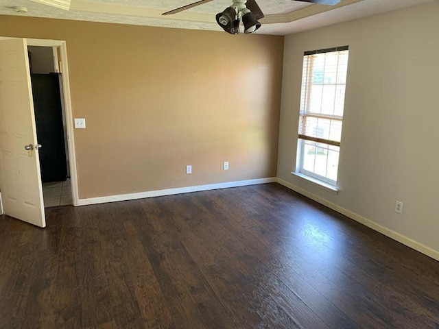 spare room featuring ceiling fan and dark hardwood / wood-style flooring