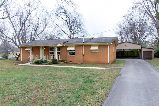 single story home featuring a porch, a garage, a front lawn, and an outdoor structure