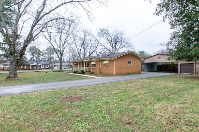 view of front of house with an outbuilding and a front yard