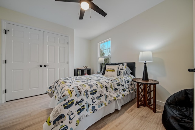 bedroom featuring ceiling fan, light hardwood / wood-style floors, and a closet