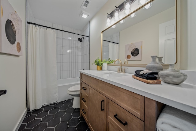 full bathroom featuring tile patterned flooring, vanity, toilet, and shower / bath combo with shower curtain