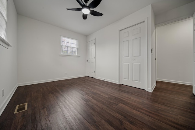 unfurnished bedroom with dark hardwood / wood-style flooring and ceiling fan