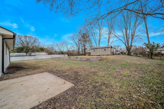 view of yard featuring a patio and an outdoor structure