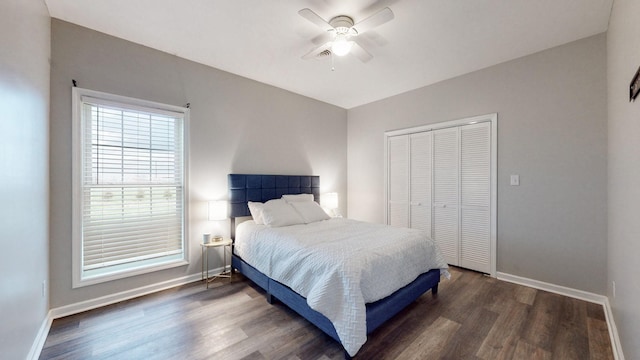 bedroom featuring ceiling fan, dark wood-type flooring, and a closet