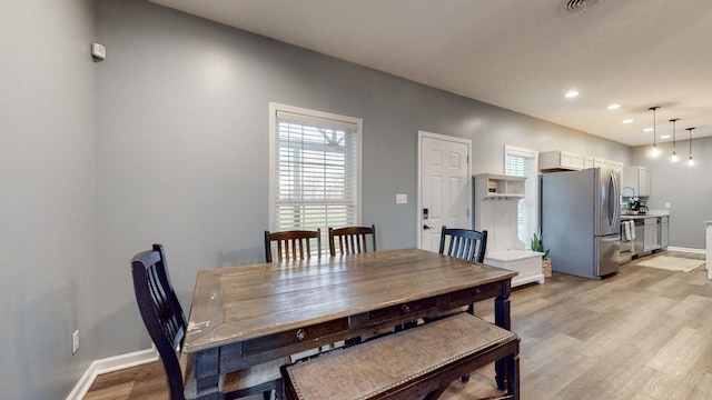 dining space featuring plenty of natural light and light hardwood / wood-style flooring