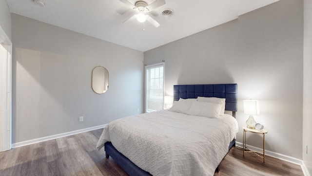 bedroom with ceiling fan, lofted ceiling, and hardwood / wood-style flooring