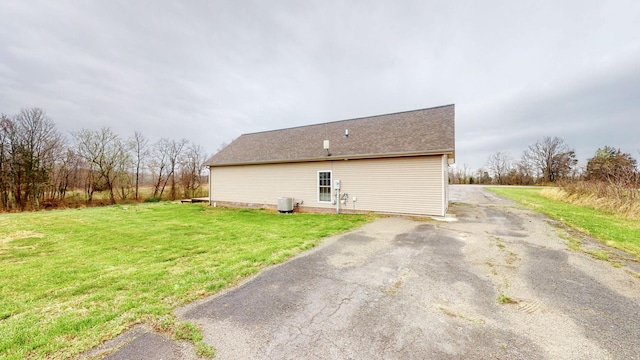 view of side of home featuring a lawn