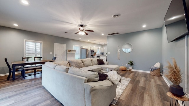 living room with hardwood / wood-style flooring and ceiling fan