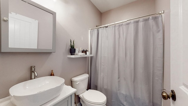 bathroom featuring toilet, sink, and walk in shower