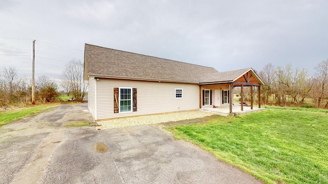 view of front of house with a patio area and a front yard