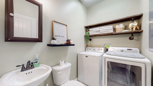 laundry area with washer and clothes dryer and sink