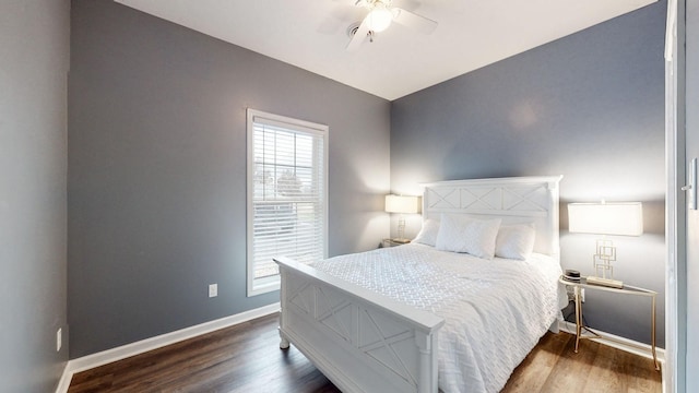 bedroom with dark hardwood / wood-style flooring and ceiling fan