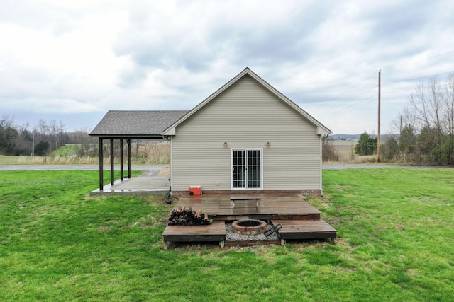 back of house featuring a patio, a yard, and a fire pit