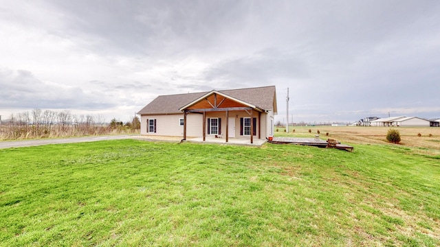 view of front of house with a front lawn and a patio