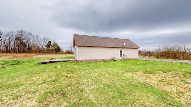 view of property exterior with a lawn and a wooden deck