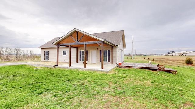 view of front of home with a patio, a front yard, and a deck