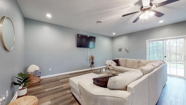 living room featuring ceiling fan and hardwood / wood-style flooring