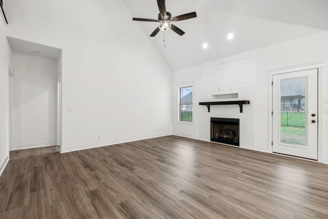 unfurnished living room with a fireplace, hardwood / wood-style floors, high vaulted ceiling, and ceiling fan