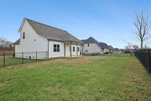 back of house featuring a yard and a patio