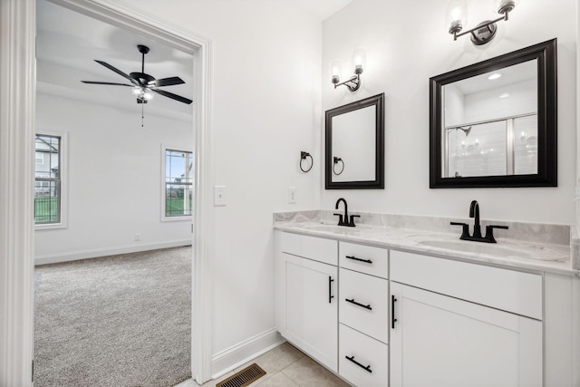 bathroom with tile patterned floors, ceiling fan, vanity, and walk in shower