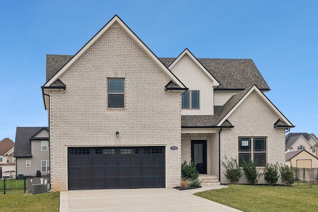 view of front of house with central AC, a garage, and a front lawn