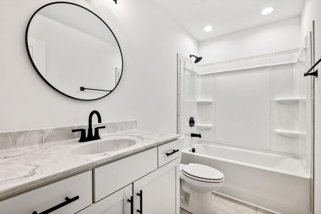 full bathroom with tile patterned floors, vanity, toilet, and washtub / shower combination