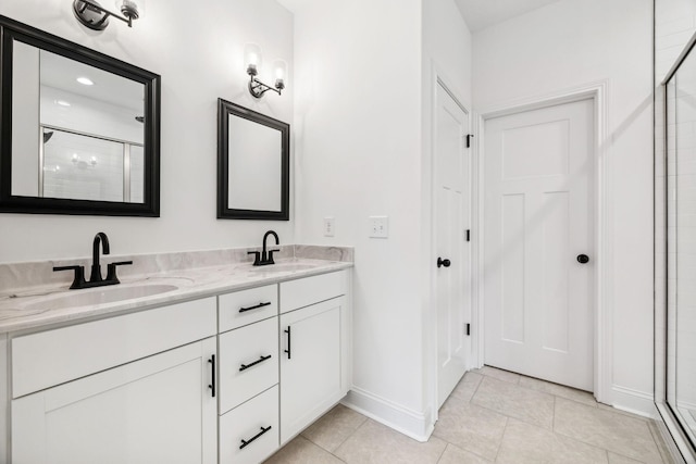 bathroom featuring vanity, tile patterned floors, and a shower with shower door