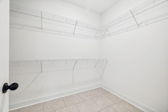 walk in closet featuring light tile patterned floors