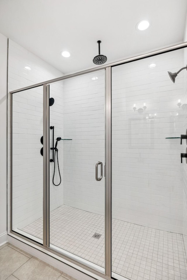 bathroom featuring tile patterned floors and a shower with door